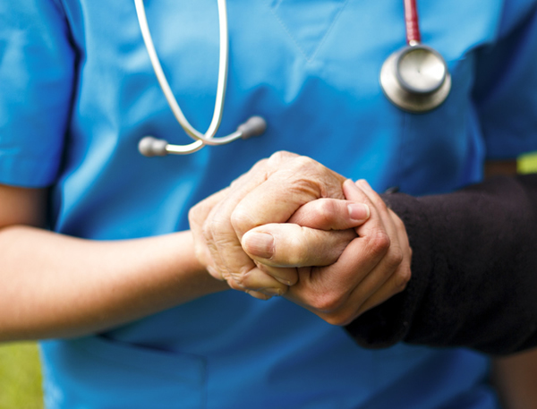 Nurse Holding the Hand of a Patient
