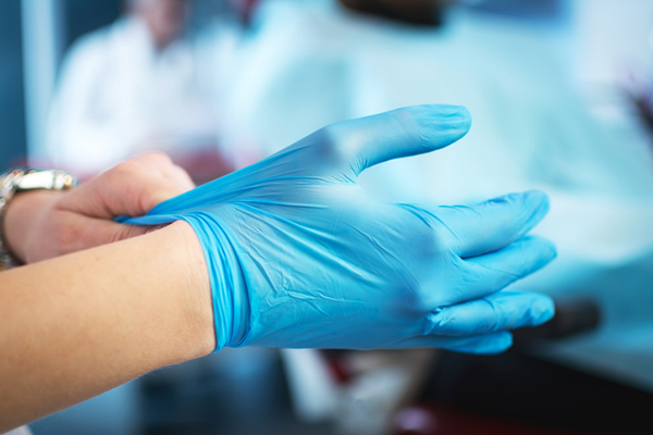 Doctor Wearing Blue Surgical Gloves